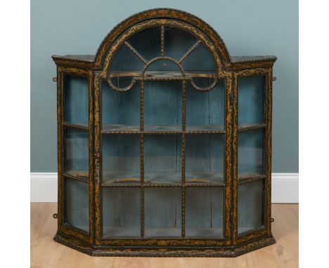 A Dutch green-painted hanging wall cabinet With an arched top, an astragal glazed door and canted side panels, the interior w