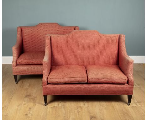 A pair of pink upholstered two-seater sofas With arching backs and square tapering legs terminating in ceramic castors to the