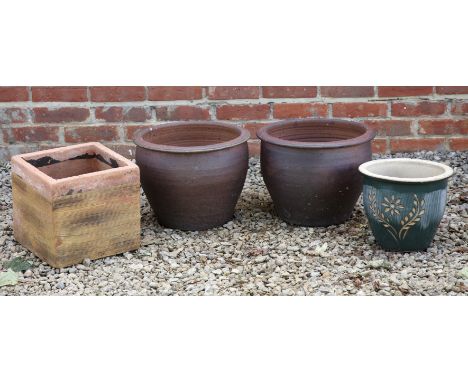 A collection of four planters A pair of circular terracotta planters; one square section terracotta planter; and a further gr