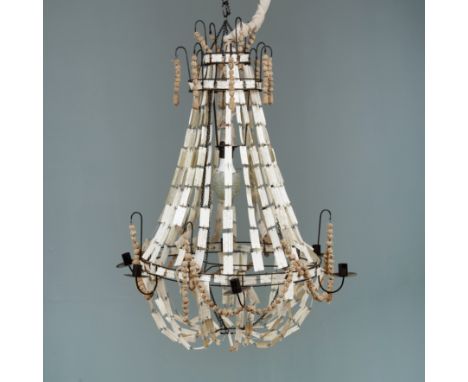 A decorative chandelier or electrolier With swags of old calligraphy-covered paper to the wrought iron frame, the frame with 