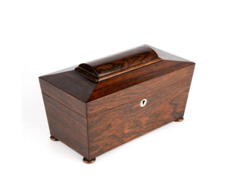 A Regency rosewood tea caddy and a Victorian rosewood sewing box The tea caddy of sarcophagus form with turned bun feet; toge
