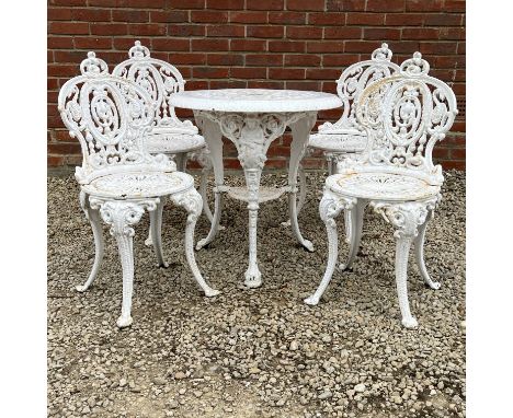 A cast iron garden table and four garden chairs The table with a pierced circular top and cast with figures of Brittania to t