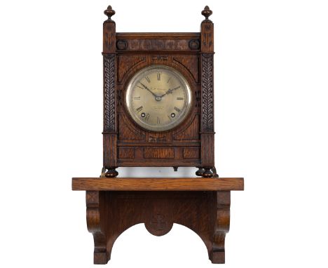 A 19th century oak mantel clock and bracket The oak case with Gothic ornament and Roman dial signed 'G.H. Osmond, 118 St Alda