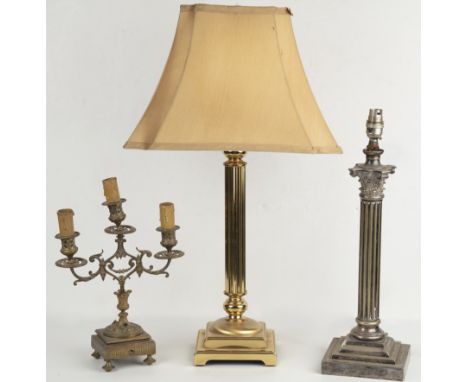 Three table lamps A silver plated lamp styled as a Corinthian column on a stepped base; a brass lamp with a fluted support on