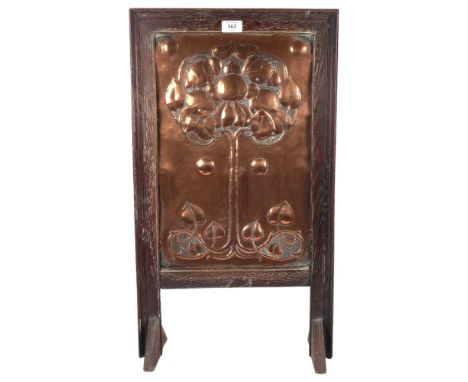 A Victorian Art Nouveau fire screen, with stylised repousse copper panel, oak-framed, H69cm 
