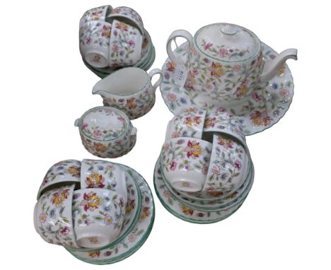 A Minton Haddon Hall tea service, comprising teapot, large plate, 12 cups, 12 saucers, 8 tea plates, cream jug, sugar bowl an