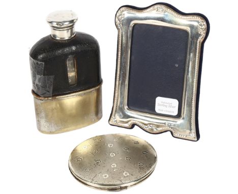 A modern sterling silver-fronted photo frame, boxed, a silver compact, and a half leather-covered hip flask, with silver lid 