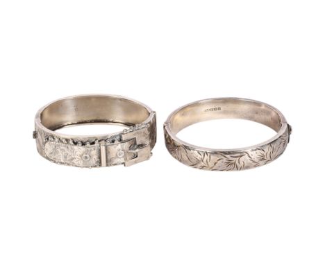 An engraved silver strap design bangle, and a floral engraved bangle (2) 