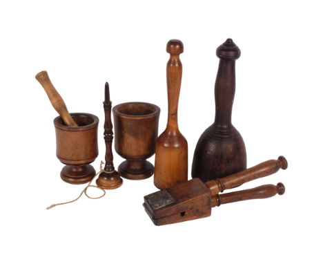 A group of Antique treen items, to include 2 pestles/masher, and 2 mortars, a ball and cup stick (no ball), and a fruit squee