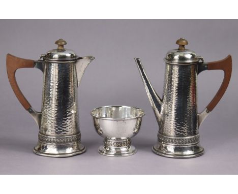 A pair of plated round tapered &amp; planished café-au-lait jugs &amp; sugar bowl; an engraved oval straight-sided tea caddy,