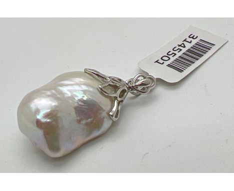 A silver and baroque pearl pendant with original tags. Approx. 3.5cm x 1.75cm including bale. Silver mark to bale. 