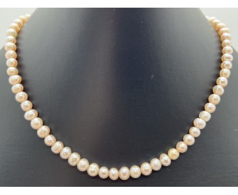 A 14" peach lustre freshwater pearl necklace with silver tone magnetic barrel clasp. Retired jewellery makers stock. 