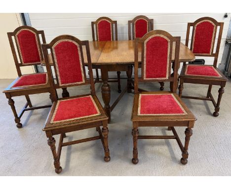 A vintage medium oak drop leaf table with shaped legs together with 6 dining chairs with red and gold re upholstered seats &a