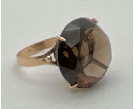 A vintage 9ct gold large smoked quartz cocktail ring. Worn hallmarks to inside of band. Tests as 9ct gold. Stone approx. 18mm