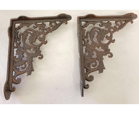 A pair of rust effect cast metal wall shelf bracelets, with decorative scroll &amp; leaf design. Approx. 28.5cm x 23cm. 