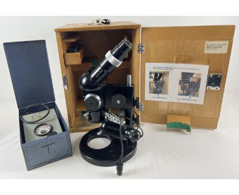 A PZO dissecting microscope with extra lens, in fitted wooden case with carry handle and key. Together with a metal cased "Wa