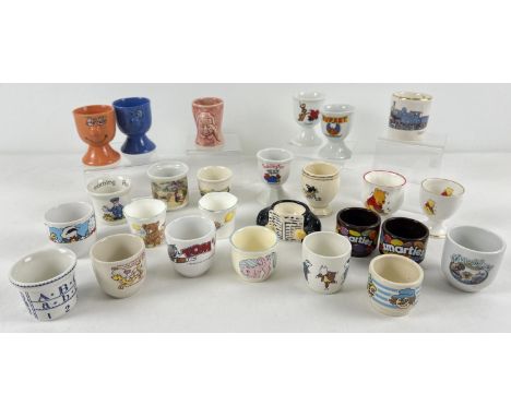 26 children's and novelty vintage ceramic egg cups. To include: Rupert Bear, Wind in The Willows, Postman Pat, My Little Pony