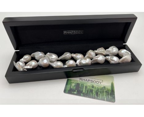 A boxed 18 inch Rhapsody organic fresh water large baroque pearl necklace with platinum clasp. Complete with certificate and 