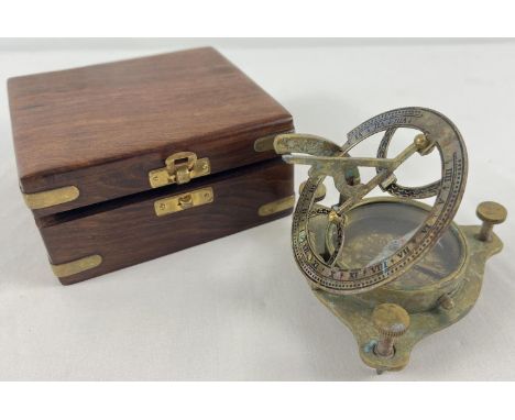 A brass sextant compass in a brass banded wooden box. 