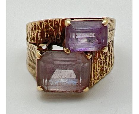 A vintage 9ct gold 2 stone dress ring with textured design to shoulders. Set with baguette cut amethyst and Rose de France st