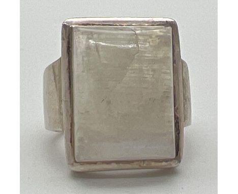 A modern design silver dress ring set with a large square cut moonstone. Silver marks to inside of band. Ring size Nï¿½. 