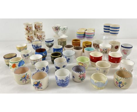 A collection of 48 ceramic egg cups in varying designs. To include: Poole, Honiton pottery, Hornsea, Kirkham's, Royal Doulton