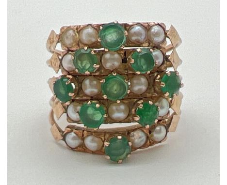 A vintage gold, emerald and seed pearl harem ring. Ring consists of 5 small bands each set with small round cut emeralds and 