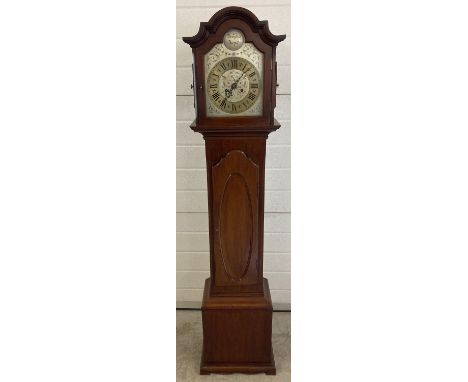 A vintage mahogany cased Tempus Fugit Grandmother clock with shaped top. Engraved detail to metal face. Complete with pendulu
