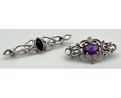 2 decorative silver stone set brooches. A celtic design bar brooch set with marquise cut black onyx, together with a pierced 