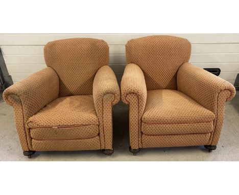A pair of vintage 1930's horse hair armchairs. With wooden bun front feet, raised on brass castors. In orange and red upholst
