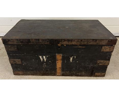 A vintage pine box, painted black with metal banded corners and lid edging. Painted 'W.C' monogram to front. Approx. 31 x 67 