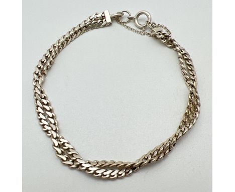A 925 silver double twisted design curb chain bracelet with spring ring clasp and safety chain. Fully hallmarked to joining l