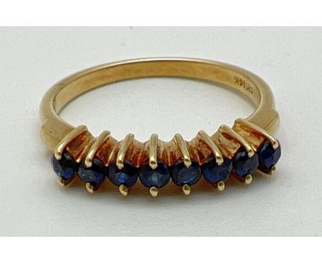 A 14ct gold half eternity style ring set with 8 small round cut sapphires. Hallmarked to inside of band. Ring size Lï¿½. 