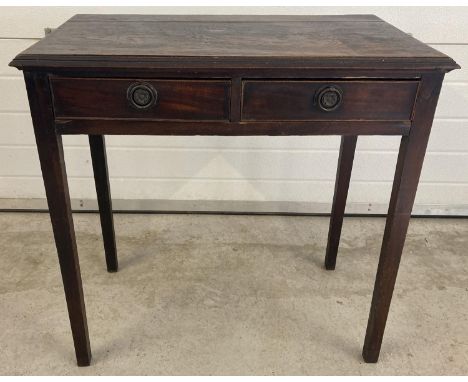 A vintage dark oak 2 drawer hall/console table with brass hooped handles and straight legs. Approx. 76cm tall x 74.5cm wide. 