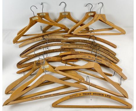 22 vintage wooden advertising coat hangers for tailors, hotels and cleaners. To include: William Turner Stowmarket, Lewis Bru