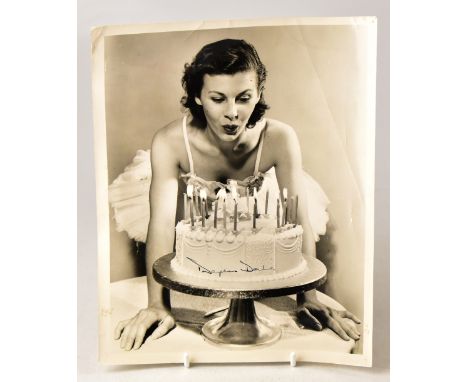 DAPHNE DALE; a black and white promotional photograph showing the star blowing candles out on a cake with annotated details v