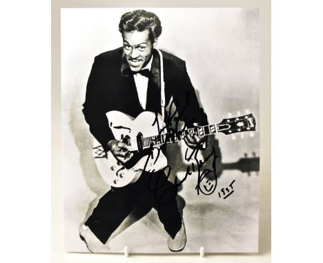 CHUCK BERRY; a black and white photograph of the star with inscription, signature and doodle, 25.5 x 20cm.We have not authent