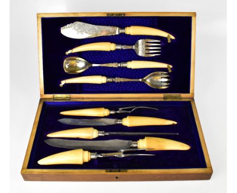 An early Edwardian oak cased set of hallmarked silver and ivory handled serving cutlery to include a pair of fish serving kni