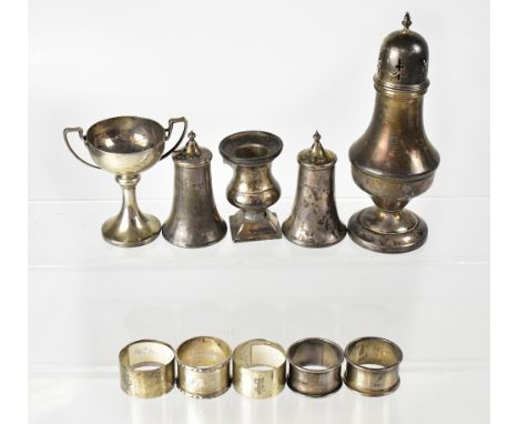 A mixed lot of hallmarked silver items to include a baluster form sugar caster, a small twin-handled trophy cup, five various