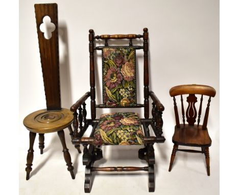 A children's Victorian-style rocking chair with upholstered seat and back, on bobbin turned supports, height 71cm, a reproduc