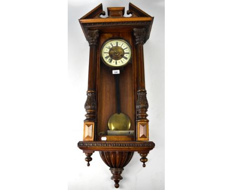 A late 19th early/20th century mahogany cased eight day Vienna-style wall clock, broken swan neck pediment above ceramic and 