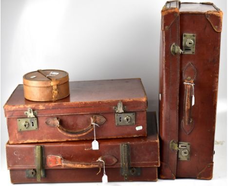 Three vintage brown leather suitcases, the largest with reinforced corners and a leather collar box, width of largest 66cm (4