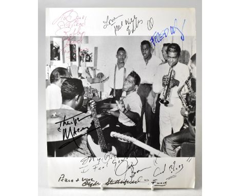 JAMES BROWN; a single page from a book or magazine bearing numerous signatures including James Brown and other members of his