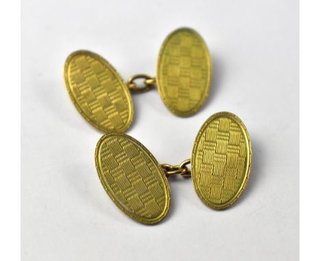 A pair of vintage 1920s 9ct gold oval cufflinks with engine turned chequerboard design, united by gold chain, approx 5.8g.