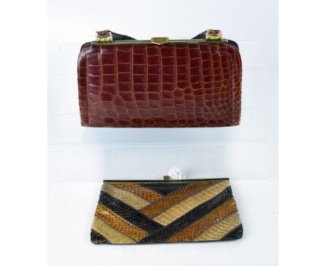 A vintage rust brown crocodile handbag, gilt metal clasp, two compartments to interior and one zip-up compartment and a retro