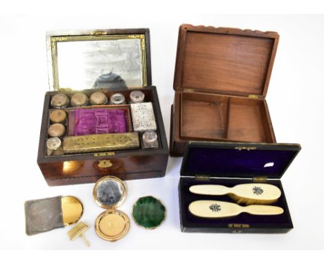 A 19th century walnut travelling toiletry box containing original glass ink bottles, storage pots, rectangular dressing table