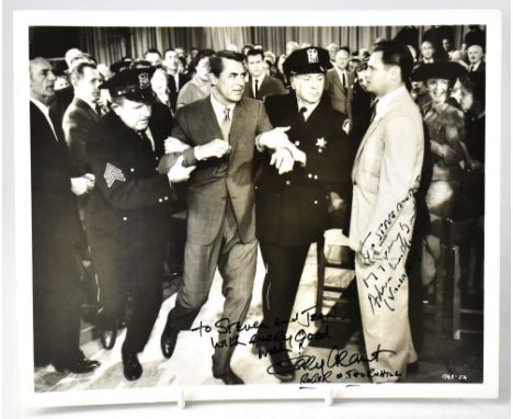CARY GRANT; a black and white photograph, from the film 'North by North-West', bearing inscription and star's signature, also