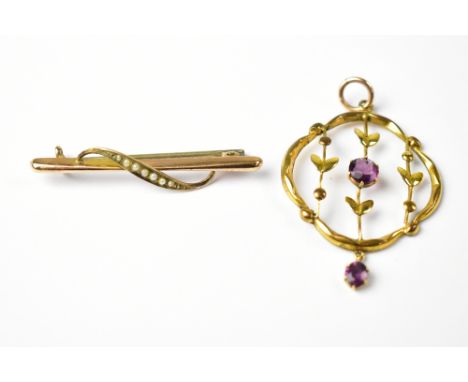 A 9ct gold bar brooch with seed pearl clad leaf and an unmarked yellow metal necklace drop with small claw set purple stone d