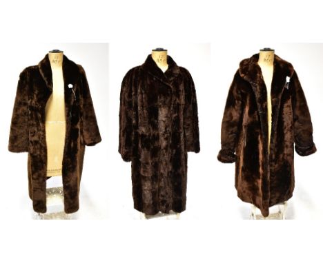 Three vintage simulated fur coats comprising a mink-style velour coat with wide collar, hook and eye fastenings and brown lin