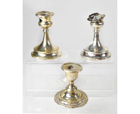 A pair of hallmarked silver candlesticks, marks rubbed (both af), height 11.5cm, and one other hallmarked silver dwarf candle